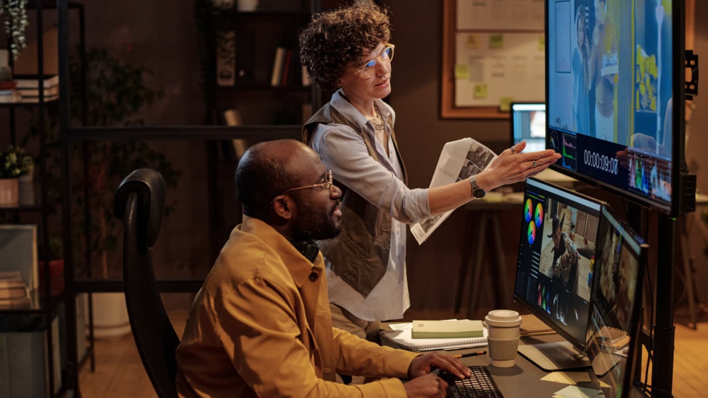 Editors reviewing a color grade in a post-production suite